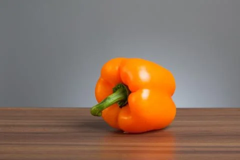 Orange pepper, raw, on table Stock Photos