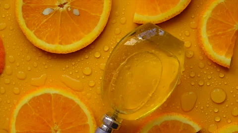 Orange perfume on a yellow background. Selective focus. Stock Footage 211619161