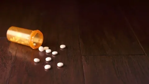 Orange Pill Bottle Falls on Left Side Slow Motion Stock Footage 78582621