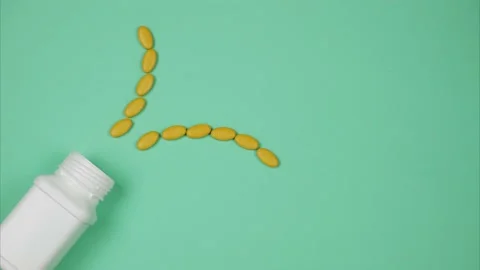 Orange pills explode out of a bottle. Stop motion animation Video stock 135346615