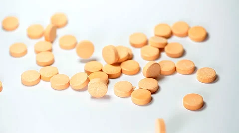 Orange pills falling Stock Footage 35713801