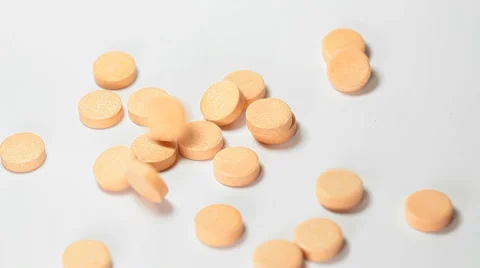 Orange pills falling Stock Footage 35713815