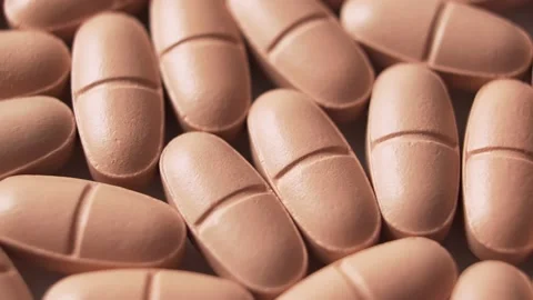 Orange pills on the table, close-up, rotation. Vídeo Stock 146964262