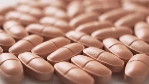 Orange pills on the table, rotation. Stock Footage 146964316