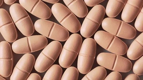 Orange pills on the table, top view, rotation. Stock Footage 146964420