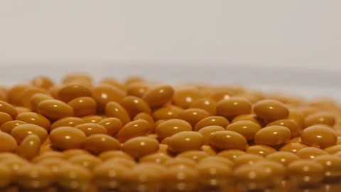 Orange pills on the turntable Stock Footage 249973148