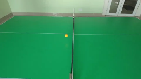 Orange ping pong ball hitting net during close up table tennis game action Stock Footage 316601565
