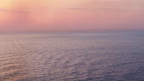Orange pink sunset over the open ocean waters with copy space Stock Footage 243384604