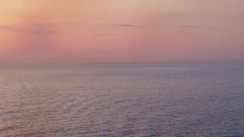 Orange pink sunset over the open ocean waters with copy space Stock Footage 243384627