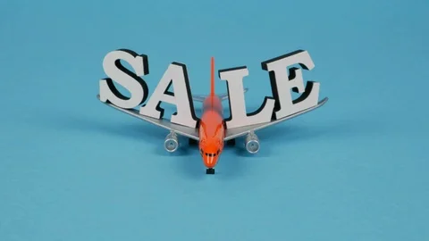 Orange plane moves to camera on wings with inscription Sale Stock Footage 119540057