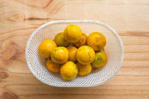 Orange in the plastic basket Stock Photos