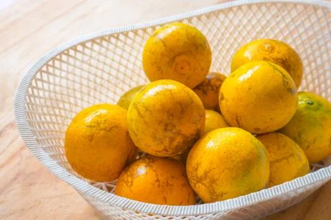 Orange in the plastic basket Stock Photos