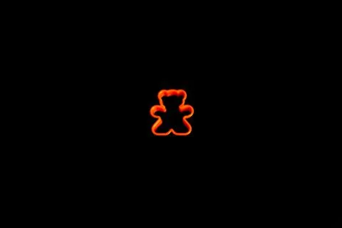 Orange plastic cookie cutter for making cookies in the shape of a teddy bear  Stock Photos
