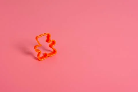 Orange plastic cookie cutter for making cookies in the shape of a teddy bear  Stock Photos