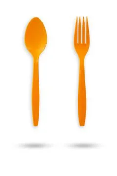 Orange plastic fork and spoon. Stock Photos