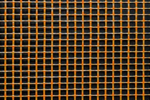Orange Plastic Grid on Black Background Surface Foto stock