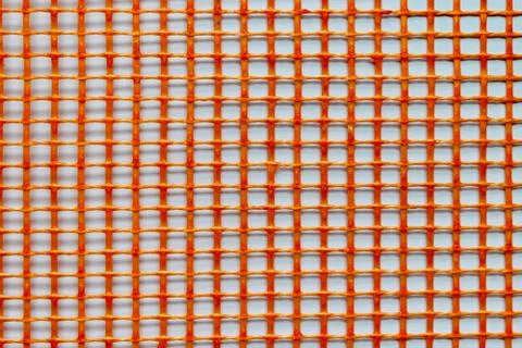 Orange Plastic Grid on White Background Surface Foto stock