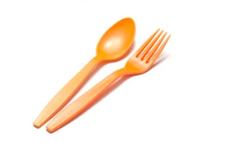 Orange plastic spoon and fork Stock Photos