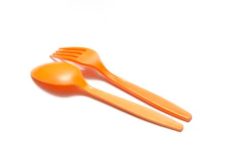 Orange plastic spoon and fork Stock Photos