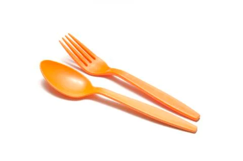 Orange plastic spoon and fork Stock Photos