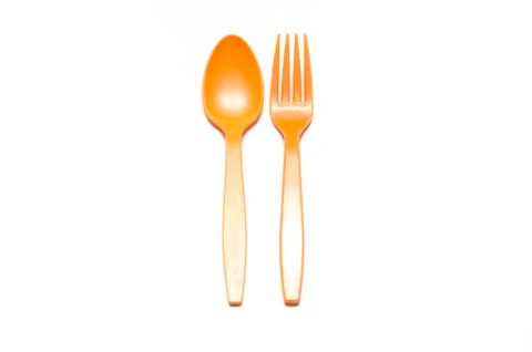 Orange plastic spoon and fork Stock Photos