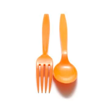 Orange plastic spoon and fork Stock Photos