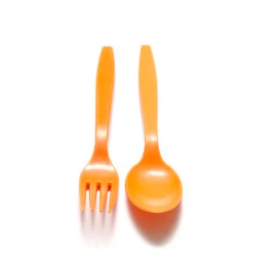 Orange plastic spoon and fork Stock Photos