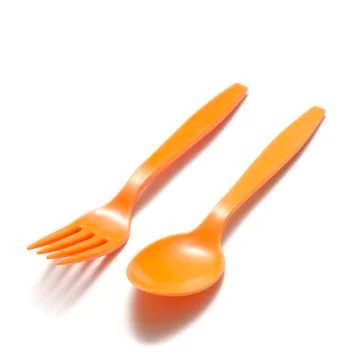 Orange plastic spoon and fork Stock Photos