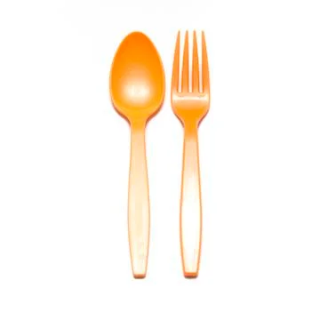 Orange plastic spoon and fork Stock Photos