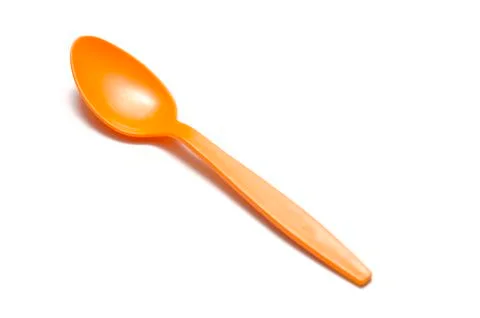 Orange plastic spoon Stock Photos