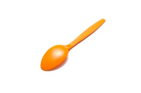 Orange plastic spoon Stock Photos