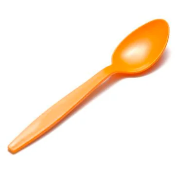 Orange plastic spoon Stock Photos