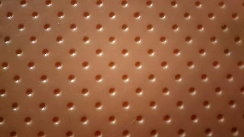 Orange plastic stool semicircular geometric pattern surface texture. Stock Photos