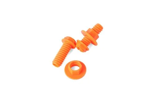 Orange plastic toy nuts and bolts building pieces isolated on white backgroun Stock Photos