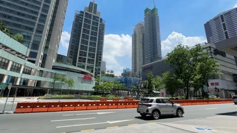 Orange plastic traffic barriers on city street with skyscrapers skyline 4k Stock Footage 337443561