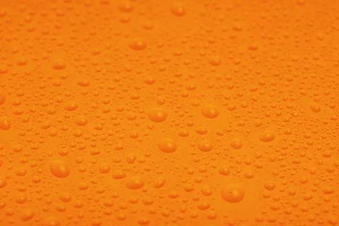 Orange plastic with water drops macro photo as background. Stock Photos