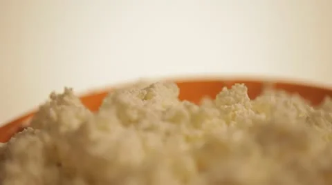Orange plate with cheese on a white background. Video stock 22244734
