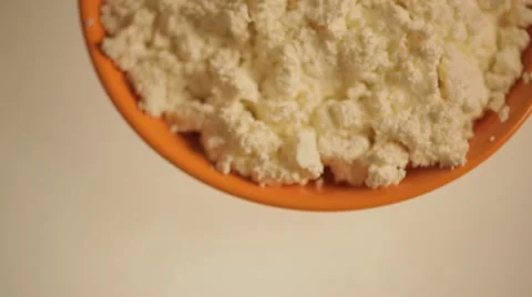 Orange plate with cheese on a white background. Stock Footage 22244742