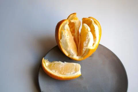 Orange on plate close up Stock Photos