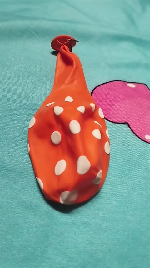 Orange Polka Dot Balloon on Blue Background Stock Footage 296035840