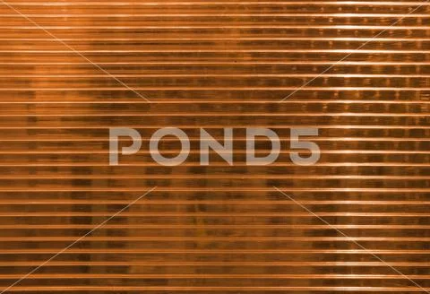 Orange polycarbonate surface with objects behind Фото
