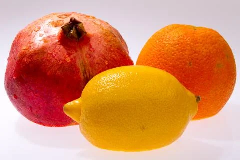 Orange pomegranate lemon Stock Photos