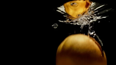 Orange pomelo falling into water Stock Footage 90386420