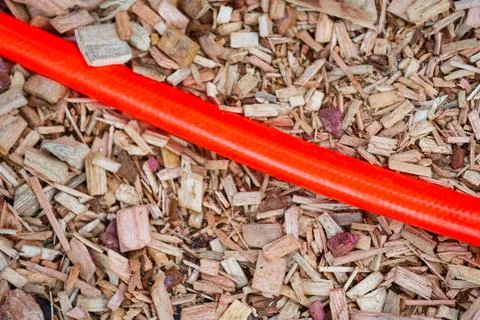 Orange power cable running across festival woodchip ground Stock Photos