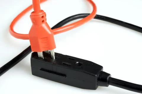 Orange power plug being connected Stock Photos