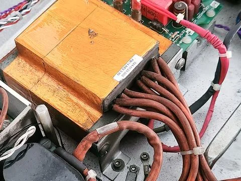Orange Power Transformer with Thick Cable Bundle. Stock Photos