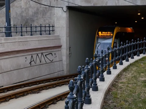 Orange public city train exiting tunnel. Video stock 79990278