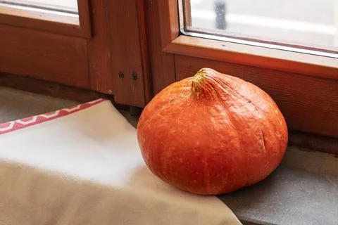 Orange pumpkin close to the window Stockfoto's