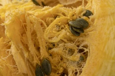 Orange pumpkin cut in half with soft juicy flesh and lots of seeds , sliced.. Stock Photos