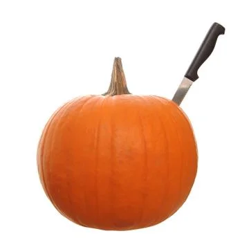 Orange pumpkin  isolated on a white background with a knife stabbed in the si Stock Photos